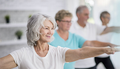 elderly woman working out with other seniors